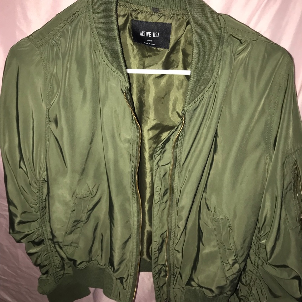 Green zip up sweater . Has pockets on sides and zip up sweaters. Size L fits M